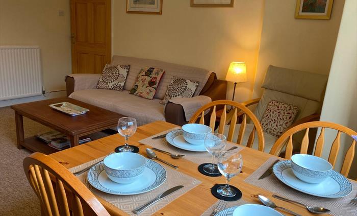 Comfy lounge and dining room. Dining table with view of the mountains